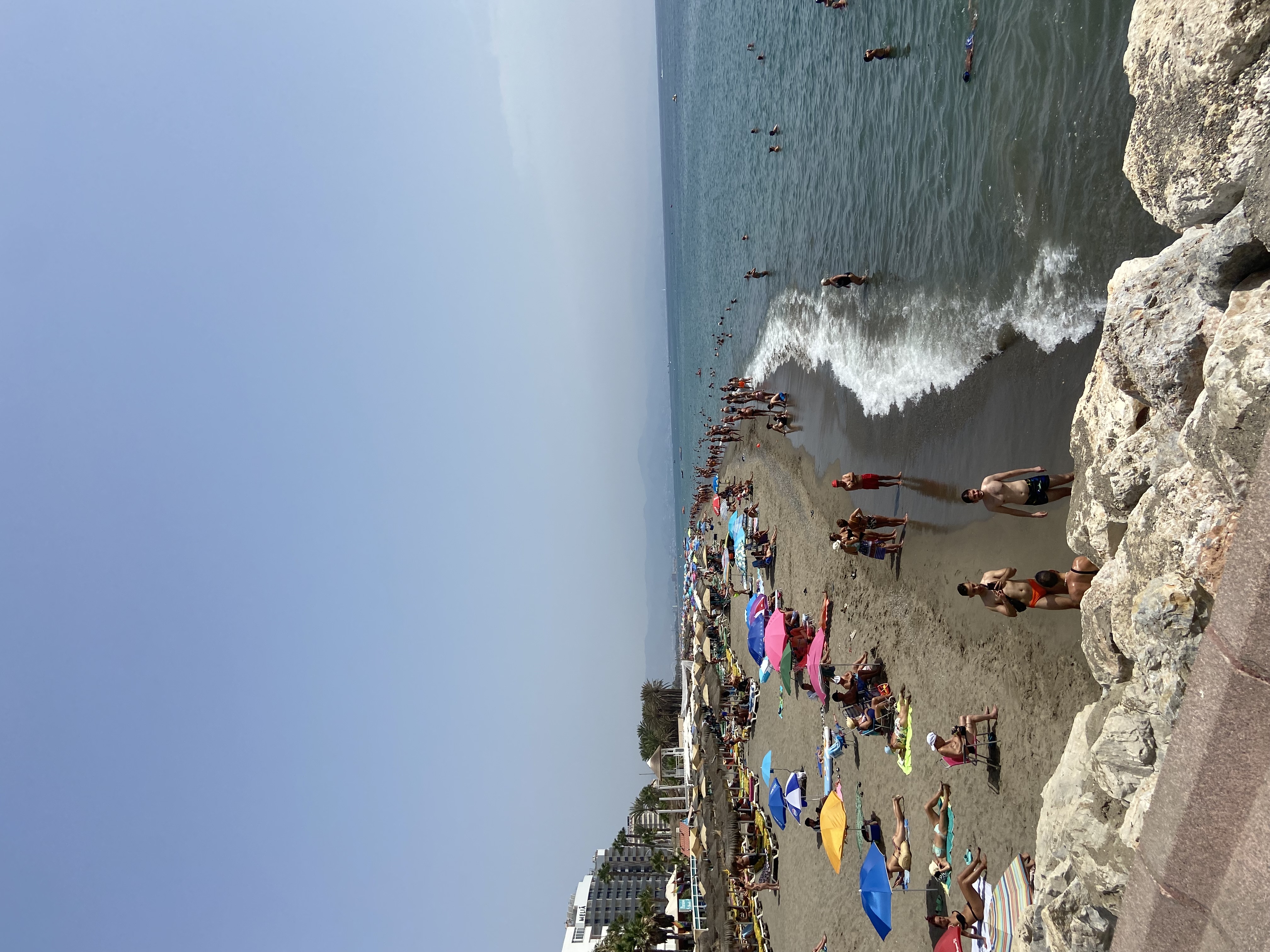 Málaga beach at midday, umbrellas, sun loungers and the Mediterranean