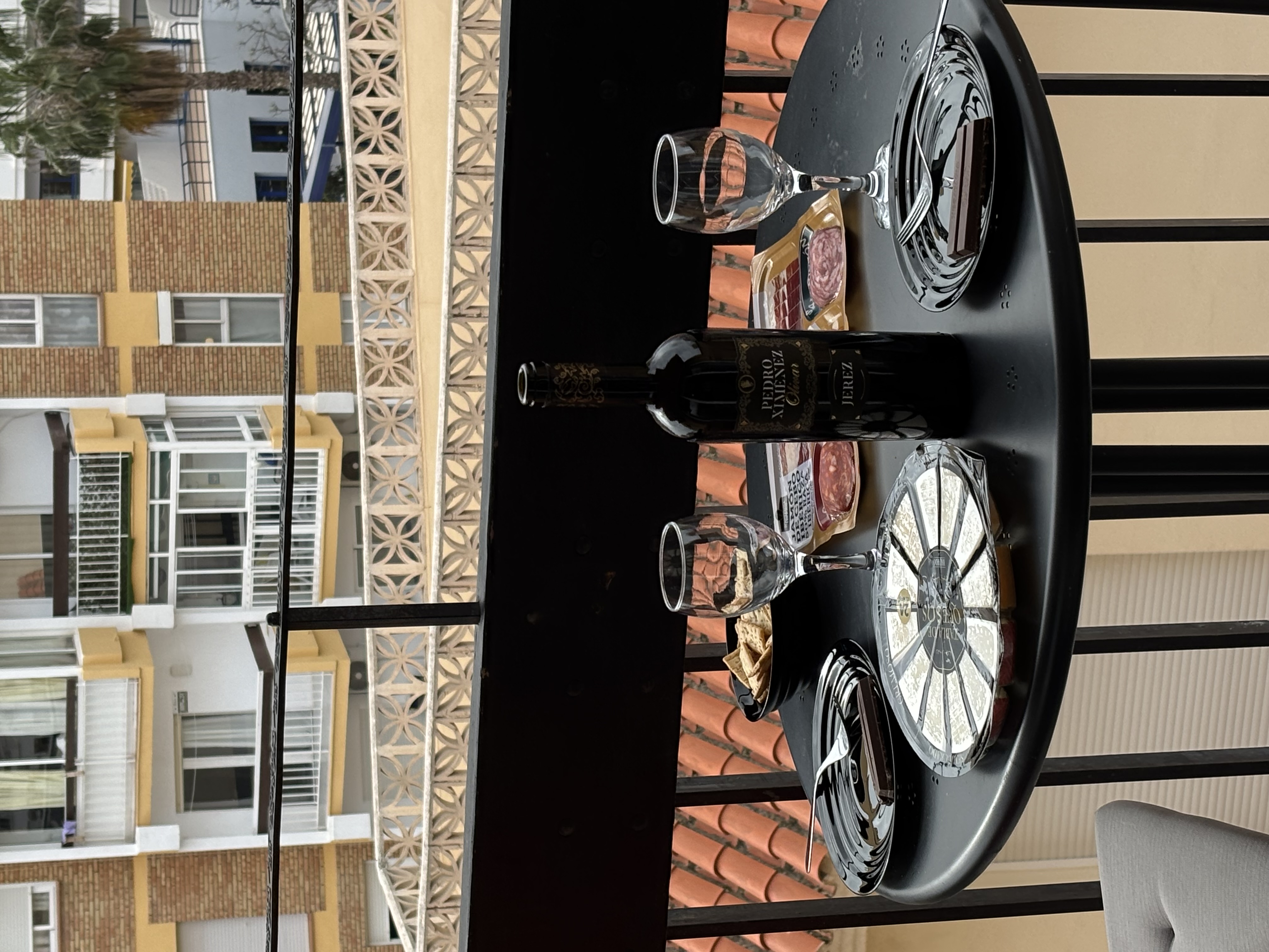 Balcony table with wine and cheese overlooking Málaga