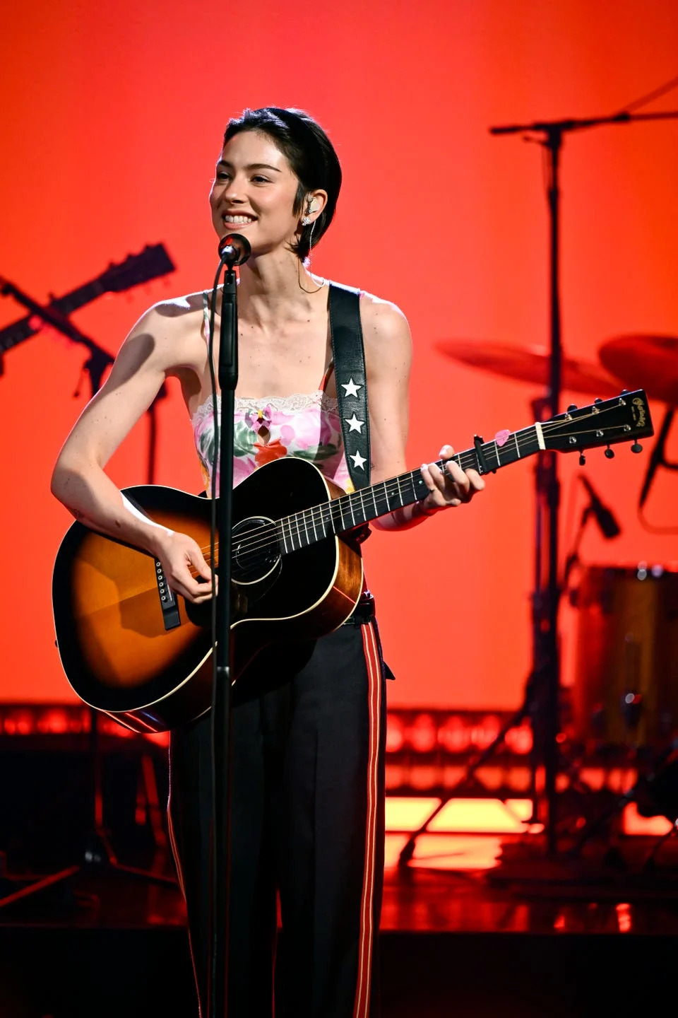 Gracie Abrams performing in a Chloé floral bodysuit and track pants